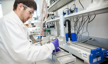 Male scientist working with lab equipment